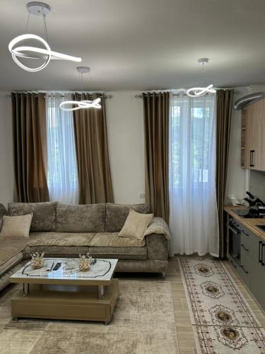 a living room with a couch and a table at Puka Retreat in Pukë