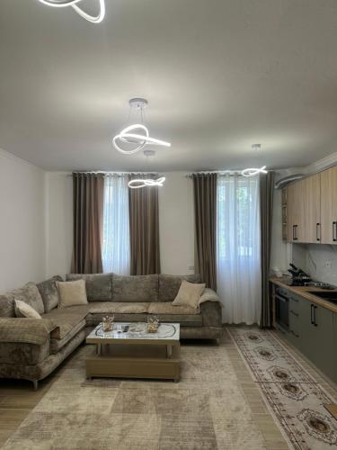 a living room with a couch and a table at Puka Retreat in Pukë