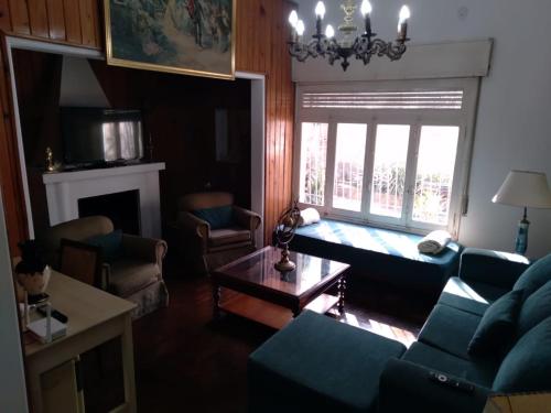 a living room with a couch and a table at La Dorada , Casa entera en Excelente Zona Residencial con cochera techada in Rosario