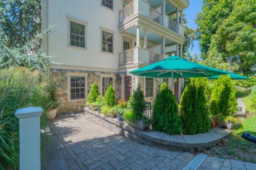 a large house with an umbrella in front of it at The Winstead Inn in Harwich