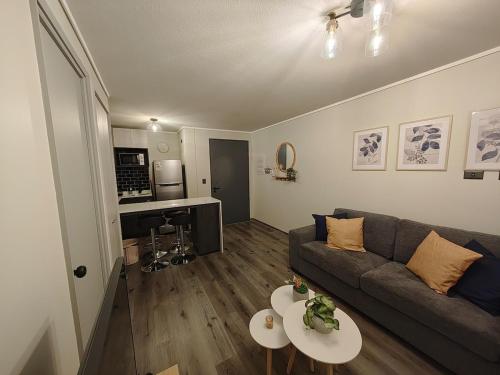 a living room with a couch and a table at Apartment with a view of the port of Valparaíso in Valparaíso