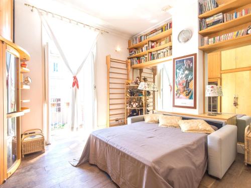 a bedroom with a bed in a room with bookshelves at Villa Michelangelo MEDIUM in Rome