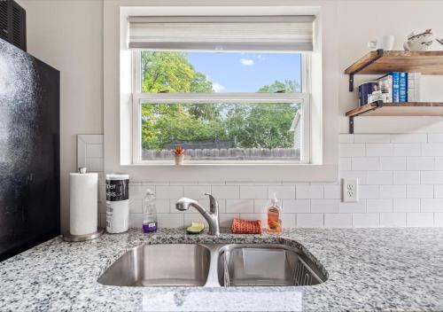 a kitchen sink with a window above it at 2BR Haven 306C Close to Charlottes Uptown in Charlotte
