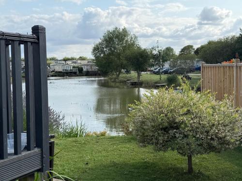 a view of a lake with ducks in the water at Andreas Riverside Retreat at 7 Lakes Country Park in Crowle