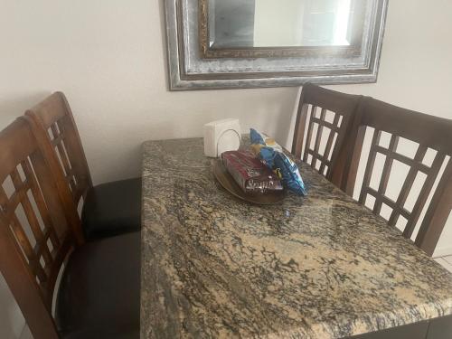 a dining room table with a counter top and chairs at Private home in West Palm in West Palm Beach