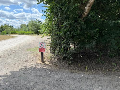 a no parking sign on the side of a road at Andreas Riverside Retreat at 7 Lakes Country Park in Crowle