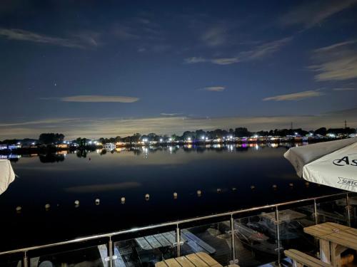 a view of a river at night with boats in the water at Andreas Riverside Retreat at 7 Lakes Country Park in Crowle