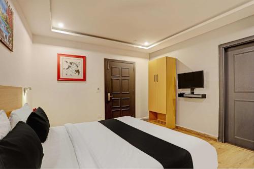 a hotel room with a bed and a television at Super Townhouse Swain Heritage in Bhubaneshwar