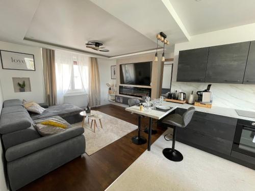 a living room with a couch and a table at Appartement Premium - Le Trente in Dijon