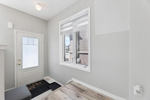a white room with a window and a door at The Devineridge Executive House in Ajax