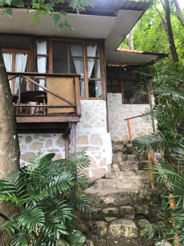 a stone house with a staircase leading to it at El Encantadero in Jobompiche