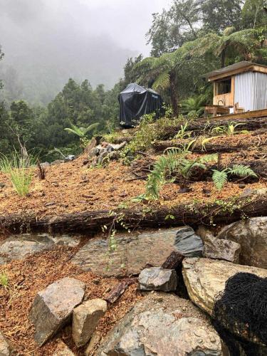 a tent on top of a hill with rocks at Golden Bay Glamping in Takaka