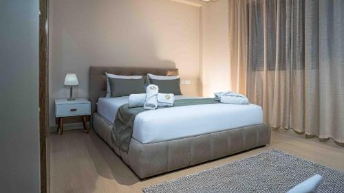 a bedroom with a bed with a stuffed animal on it at Appart Hôtel Golden Sky Home Café Restaurant & Spa in Beni Mellal