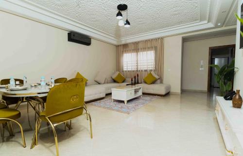 a living room with a couch and a table at Appart Hôtel Golden Sky Home Café Restaurant & Spa in Beni Mellal