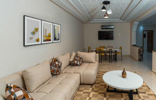 a living room with a couch and a table at Appart Hôtel Golden Sky Home Café Restaurant & Spa in Beni Mellal