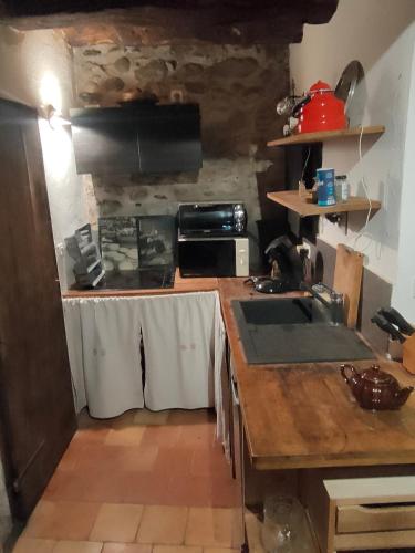 a kitchen with a sink and a counter top at Aile de la Maison de Chouliou in Balaguères