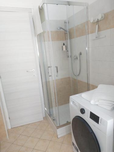 a washing machine in a bathroom with a shower at La Finestra sulla Storia in Asti
