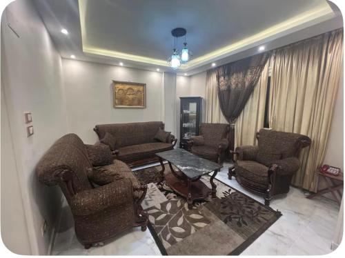 a living room with couches and chairs and a table at شقة فخمة للايجار in Cairo