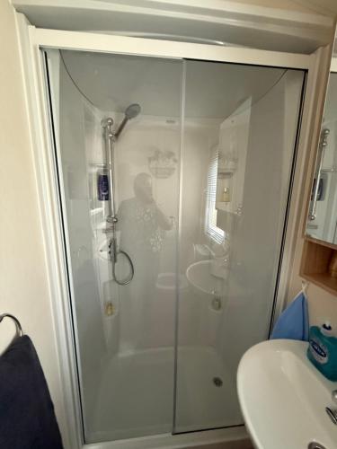 a shower stall in a bathroom next to a sink at Andreas Riverside Retreat at 7 Lakes Country Park in Crowle