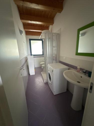 a bathroom with a sink and a washing machine at Maruta Siracusa in Arenella