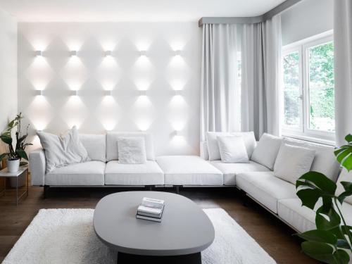 a living room with a white couch and a table at Stadtchalet Forsthaus in Kitzbühel