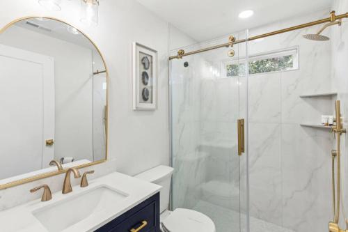 a bathroom with a shower and a toilet and a sink at Edisto Island Oasis in Edisto Island