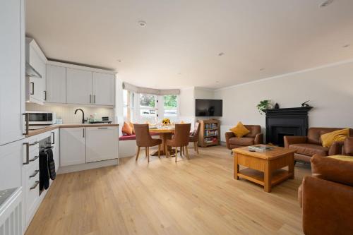 a kitchen and living room with a couch and a table at Escape to Serene Georgian Estate, near Edinburgh in Ratho