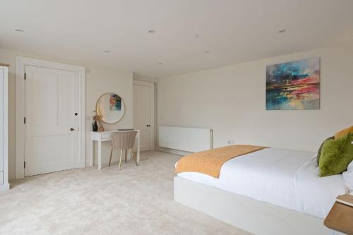 a white bedroom with a bed and a desk at Escape to Serene Georgian Estate, near Edinburgh in Ratho