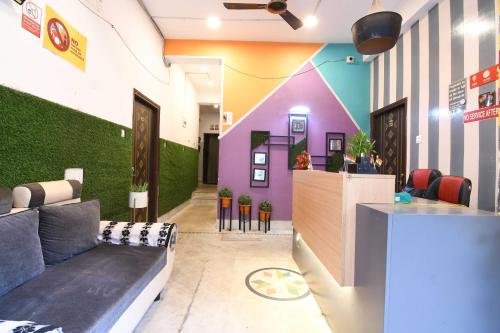 a lobby with a couch and a bar in a room at OYO 82026 BANGUR INN in Nager Bazaar