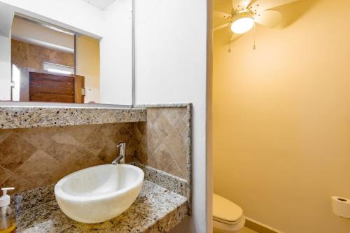 a bathroom with a sink and a toilet at Punta Mita Litibu Beachfront Studios Mar-3 in Punta Mita