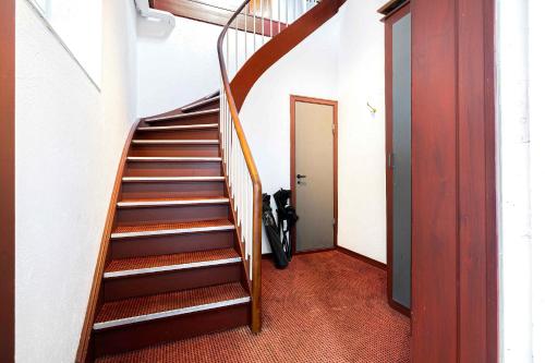 a spiral staircase in a room with a hallway at Stately Apartment Incl Consumption in Bogense