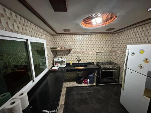 a small kitchen with a sink and a refrigerator at Dar Aguellid in Imouzzer Kandar