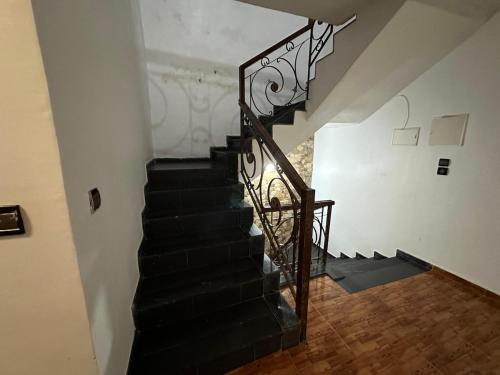 a staircase with a wrought iron railing in a house at Dar Aguellid in Imouzzer Kandar