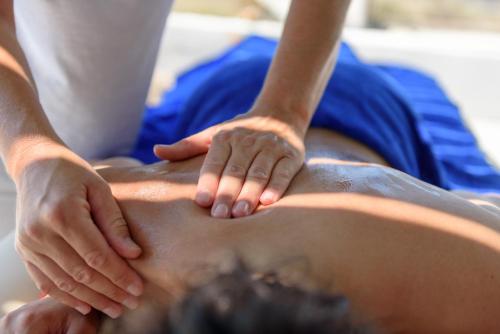 a man getting a massage on his back at Sublime Villa & Caves in Akrotiri