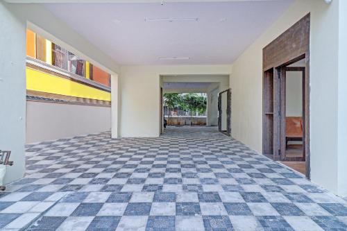 an empty hallway of a house with a checkered floor at Hotel O Abhi's R Square in Upal