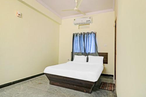 a bedroom with a bed and a window at Hotel O Abhi's R Square in Upal