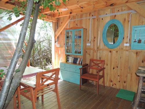 a cabin with two chairs and a desk and a mirror at Kerca Bio Farm in Kercaszomor
