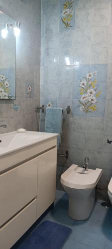 a bathroom with a toilet and a sink at CarriCHe 1 in Lisbon