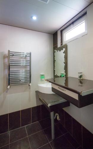 a bathroom with a sink and a mirror at Tatev Apartments in Yerevan