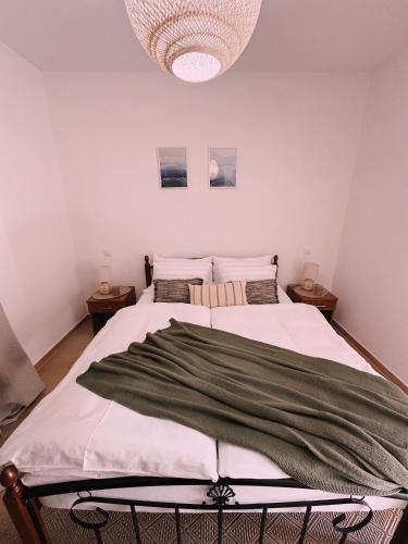 a bedroom with two beds and a chandelier at Layal Home in Bihać