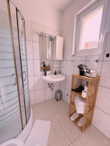 a bathroom with a toilet and a sink and a shower at Layal Home in Bihać