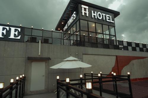 a building with an umbrella in front of a hotel at THE TIMES HOTEL in Angeles