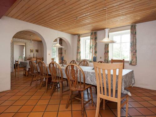 a dining room with a table and chairs at Luxury Retreat with Pool - By Traum Ferienwohnungen in Thyholm