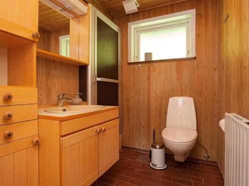 a bathroom with a toilet and a sink at Luxury Retreat with Pool - By Traum Ferienwohnungen in Thyholm