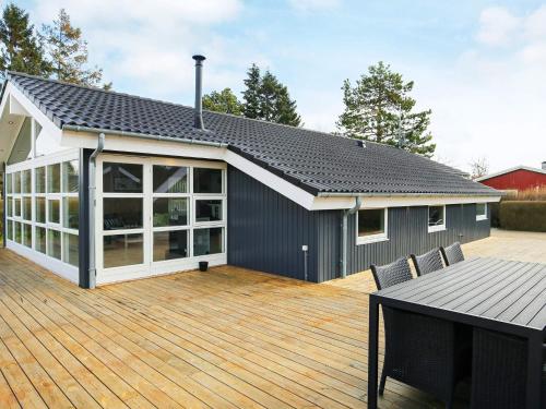 a house with a wooden deck with a patio at Luxury Retreat with Spa - By Traum Ferienwohnungen in Dannemare