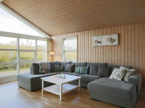 a living room with a couch and a table at Luxury Retreat with Spa - By Traum Ferienwohnungen in Dannemare