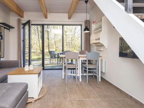 a kitchen and living room with a table and chairs at 5 star holiday home in Hovborg-By Traum in Hovborg