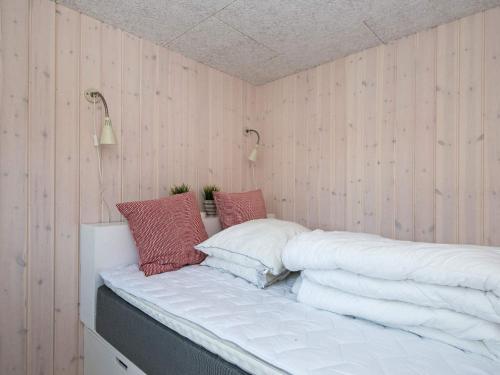 a bed with pillows on it in a room at 6 person holiday home in Odder-By Traum in Odder