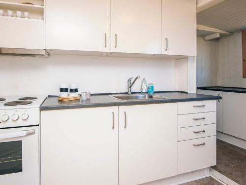 a kitchen with white cabinets and a sink at 4 person holiday home in Fanø-By Traum in Fanø