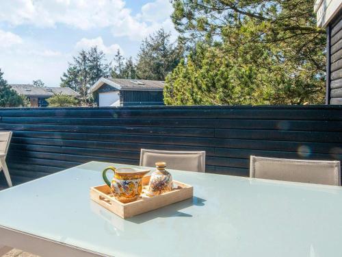 a blue table with a vase on top of it at 4 person holiday home in Fanø-By Traum in Fanø